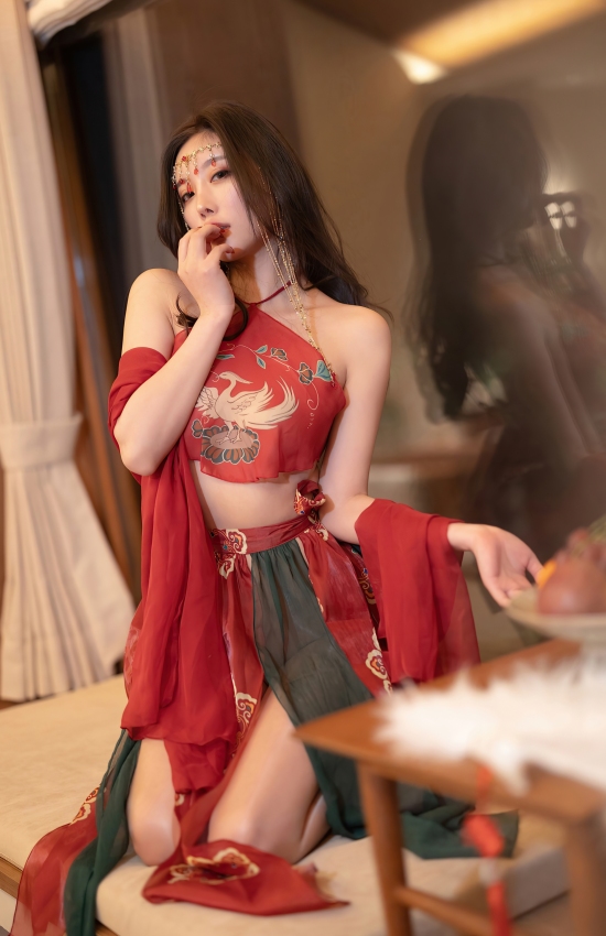 朱砂一点眉心，红纱半掩风华。她执羽扇倚窗，是古韵里走出来的惊鸿一瞥，美得令人心颤。